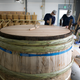 Coopers fix a wooden tub at Kenbishi in Kobe’s Nada brewing district.